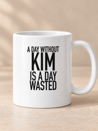 A DAY WITHOUT KIM IS A DAY WASTED mug white AI final 1350x1800