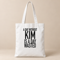 A DAY WITHOUT KIM IS A DAY WASTED tote white mockup