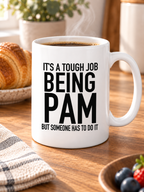 IT'S A TOUGH JOB BEING PAM BUT SOMEONE HAS TO DO IT mug lifestyle-white mockup