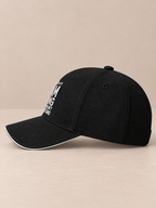 Side view of black 6-panel sandwich baseball cap with contrast brim piping