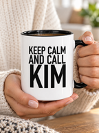 KEEP CALM AND CALL KIM mug handheld-black-white mockup