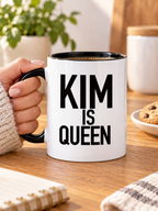 KIM IS QUEEN mug handheld-black-white mockup
